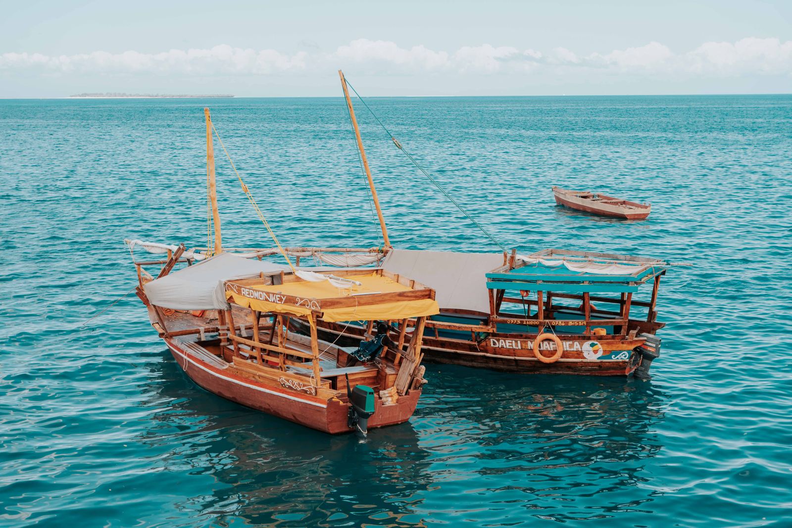 Traditional dhows sailing in the turquoise Zanzibar sea