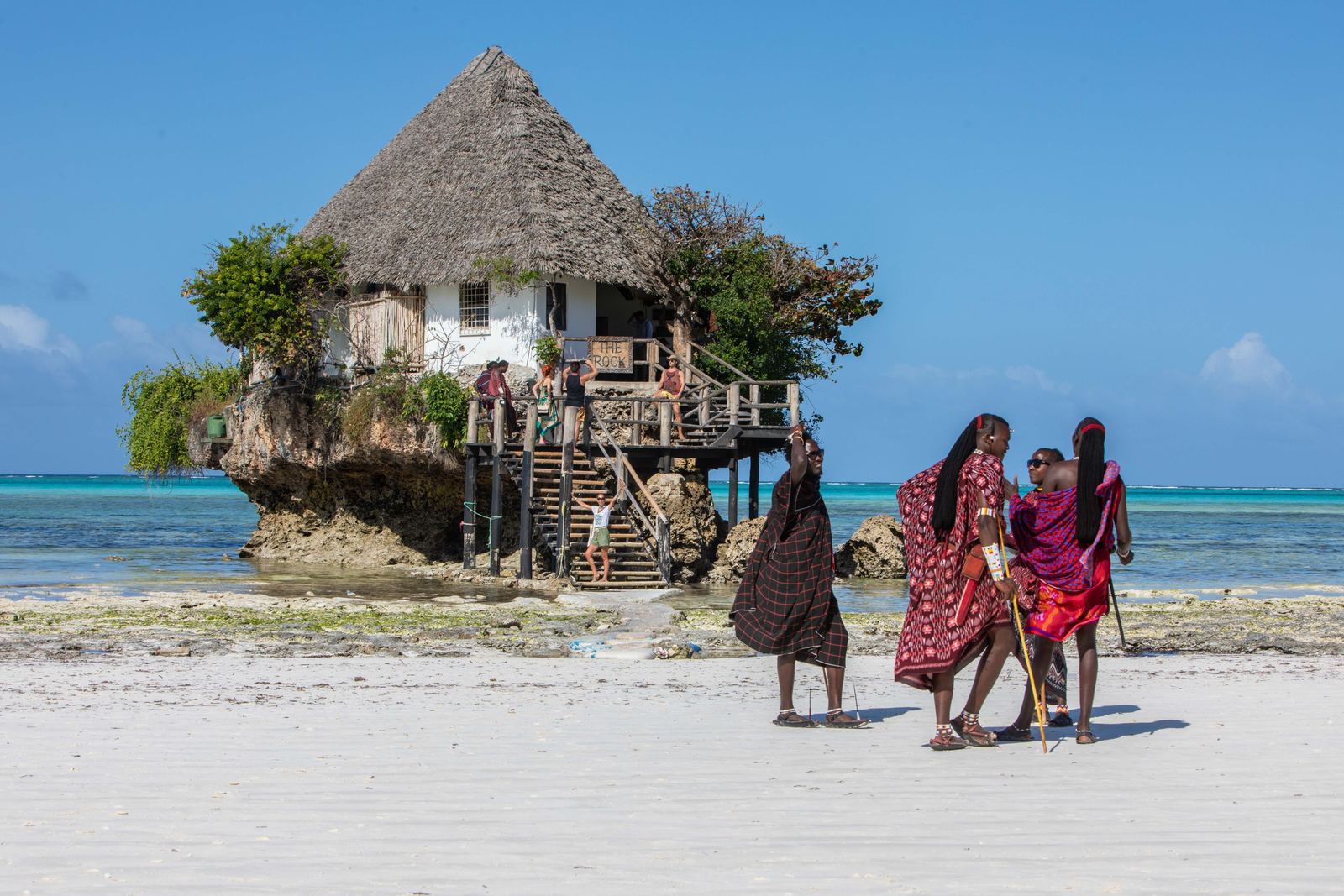 Cultural scene at The Rock restaurant on a Zanzibar beach